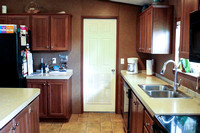 Open living/kitchen area - looking at back door into utility